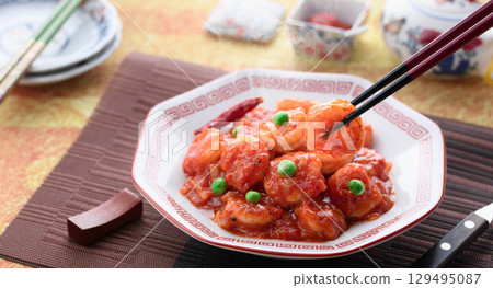 Glossy and fragrant shrimp chili. A classic Chinese dish. Colorful stir-fried shrimp in chili sauce. Perfect for advertising. Glossy and fragrant shrimp chili. A classic Chinese dish. Colorful stir-fried shrimp in chili sauce. Perfect for advertising. 129495087