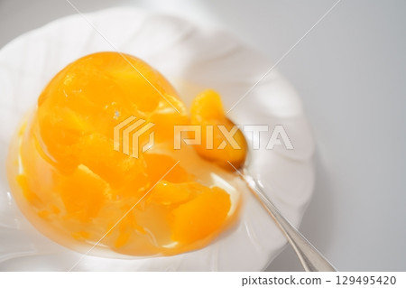 Perfect for summer. Cool, jiggly, gently shining, sparkling mandarin jelly 129495420