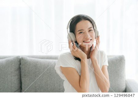 Woman listening to music on smartphone 129496847
