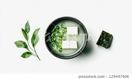 Fresh and Healthy Miso Soup with Tofu, Green Onion, Seaweed Leaf on White Surface, Minimalist Food Photography 129497906