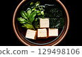 Fresh Tofu Dish with Seaweed and Green Onion Garnish in Traditional Bowl on Dark Background Fresh Tofu Dish with Seaweed and Green Onion Garnish in Traditional Bowl on Dark Background 129498106