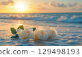 Soft White Roses on Sand at Sunrise with Ocean Waves and Gentle Light in Background Soft White Roses on Sand at Sunrise with Ocean Waves and Gentle Light in Background 129498193