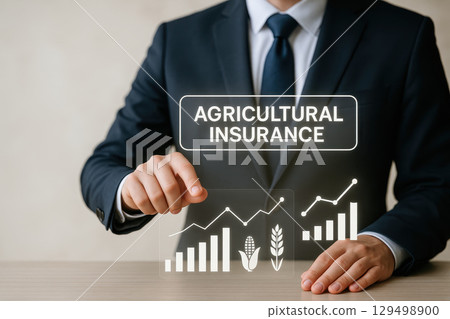 Agricultural insurance concept with business professional in suit showing growth chart and crop icons for protection and risk management in farming industry 129498900