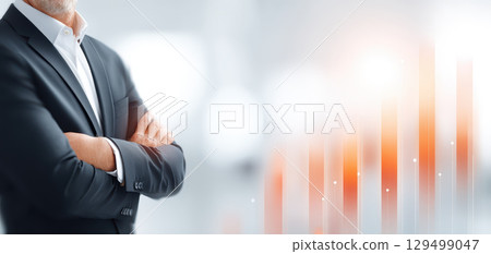 Successful confident man in suit with crossed arms standing near stock market graph with orange bars showing growth and progress in financial investment concept Successful confident man in suit with crossed arms standing near stock market graph with orange bars showing growth and progress in financial investment concept 129499047