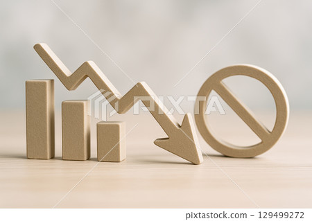 Economic recession and financial crisis cause stock market decline shown by downward arrow and bar chart with prohibition sign symbolizing economic downturn and financial instability 129499272