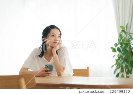 A woman in her 30s with a worried expression A woman in her 30s with a worried expression 129499350