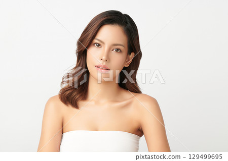 A beautiful young Asian woman with clean, fresh skin against a white background. Skincare, facial treatment, cosmetology, beauty, and spa. An elegant portrait of an Asian woman. A beautiful young Asian woman with clean, fresh skin against a white background. Skincare, facial treatment, cosmetology, beauty, and spa. An elegant portrait of an Asian woman. 129499695