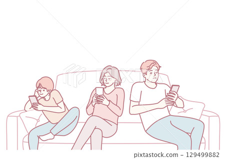 Parents with child sit on sofa using cellphones 129499882