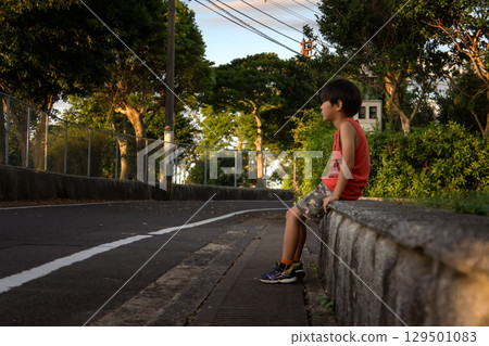 <Material> A boy exhausted from the summer heat <Material> A boy exhausted from the summer heat 129501083
