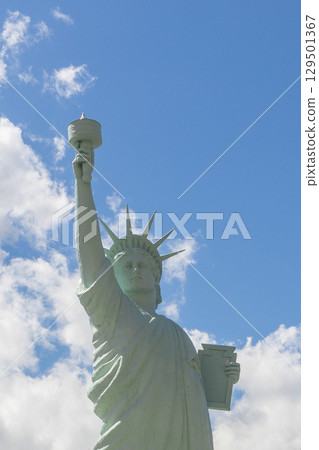 Statue of Liberty standing tall with torch held high, symbolizing freedom and democracy 129501367