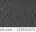 Black crumpled paper texture background with rough folds. Perfect for grunge design, packaging, vintage style 129501473