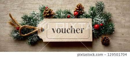 paper tag with word voucher on christmas tree branch background paper tag with word voucher on christmas tree branch background 129501704