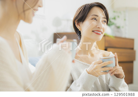 Woman drinking hot coffee in her room Woman drinking hot coffee in her room 129501988