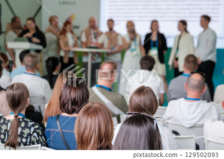 Blurred conference audience listening to speakers during a business seminar event Blurred conference audience listening to speakers during a business seminar event 129502093