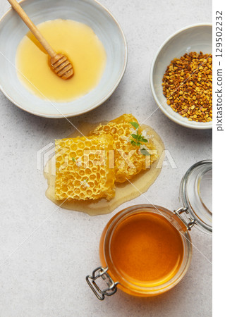 Composition of honey, honeycombs and bee pollen creating delicious golden spread Composition of honey, honeycombs and bee pollen creating delicious golden spread 129502232