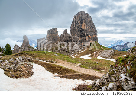Cinque Torri rock formations in the Dolomites (Dolomiti, Dolomiten), Italy. Majestic stone towers rising above the snowy alpine landscape, a famous spot for climbers and hikers Cinque Torri rock formations in the Dolomites (Dolomiti, Dolomiten), Italy. Majestic stone towers rising above the snowy alpine landscape, a famous spot for climbers and hikers 129502585