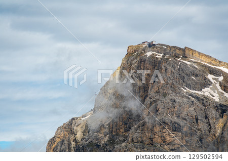 Mountain peak near Cinque Torri in the Dolomites (Dolomiti, Dolomiten), Italy. A cable car ascends to the summit, offering breathtaking alpine views and access to hiking trails 129502594