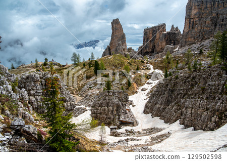 Cinque Torri rock formations in the Dolomites (Dolomiti, Dolomiten), Italy. Majestic stone towers rising above the snowy alpine landscape, a famous spot for climbers and hikers 129502598