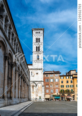 Panoramic view of Chiesa di San Michele in Foro in the historic center of Lucca Italy on a sunny summer day with clear blue sky and warm light on the ancient architecture 129502703