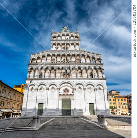 Panoramic view of Chiesa di San Michele in Foro in the historic center of Lucca Italy on a sunny summer day with clear blue sky and warm light on the ancient architecture Panoramic view of Chiesa di San Michele in Foro in the historic center of Lucca Italy on a sunny summer day with clear blue sky and warm light on the ancient architecture 129502704