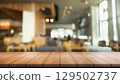 Empty wooden table top with lights bokeh on blur restaurant background. 129502737