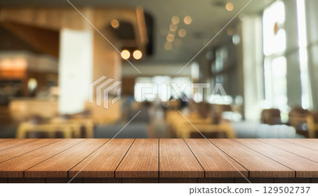 Empty wooden table top with lights bokeh on blur restaurant background. 129502737