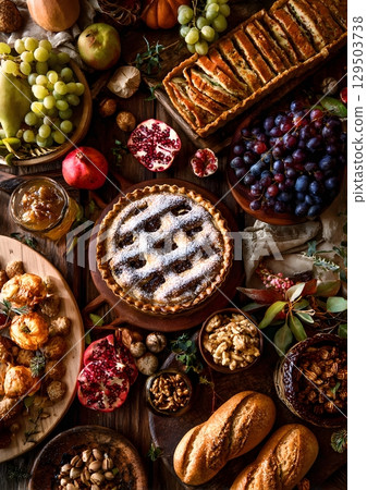 autumn food spread with pies breads and fruits 129503738