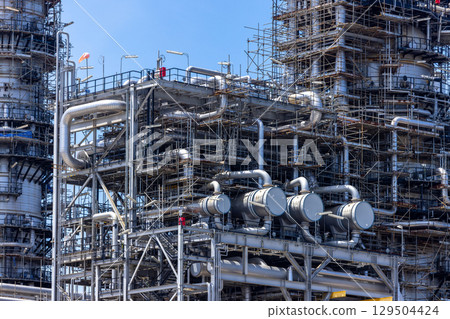 Oil and Gas refinery petrochemical plant industrial on blue sky background, Oil and Gas refinery petrochemical plant pipeline steel, Oil and Gas refinery factory maintenance, Global energy refinery. Oil and Gas refinery petrochemical plant industrial on blue sky background, Oil and Gas refinery petrochemical plant pipeline steel, Oil and Gas refinery factory maintenance, Global energy refinery. 129504424