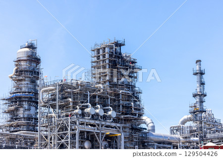 Oil and Gas refinery petrochemical plant industrial on blue sky background, Oil and Gas refinery petrochemical plant pipeline steel, Oil and Gas refinery factory maintenance, Global energy refinery. 129504426