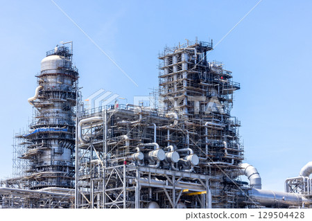 Oil and Gas refinery petrochemical plant industrial on blue sky background, Oil and Gas refinery petrochemical plant pipeline steel, Oil and Gas refinery factory maintenance, Global energy refinery. 129504428