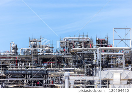 Oil and Gas refinery petrochemical plant industrial on blue sky background, Oil and Gas refinery petrochemical plant pipeline steel, Oil and Gas refinery factory maintenance, Global energy refinery. 129504430