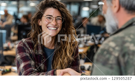 job applicant shaking hands with HR manager, natural office light 129505287