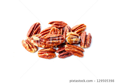 Delicious salted pecan nuts scattered. Delicious salted pecan nuts scattered. 129505398