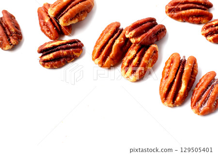Delicious salted pecan nuts scattered. 129505401