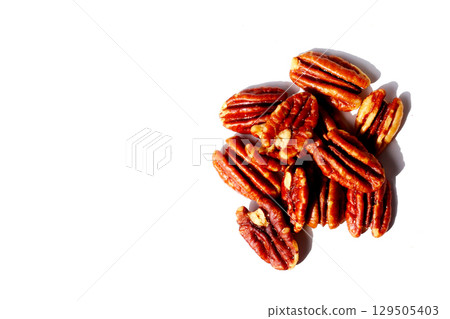Delicious salted pecan nuts scattered. 129505403