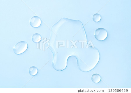Drops of cosmetics on a blue background Drops of cosmetics on a blue background 129506439