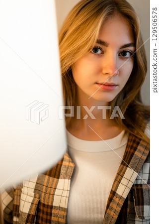 Woman in Checkered Shirt Facing Camera with Soft Smile Woman in Checkered Shirt Facing Camera with Soft Smile 129506578