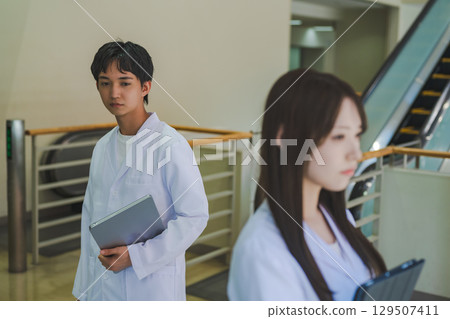 Portrait of a person wearing a white coat Portrait of a person wearing a white coat 129507411