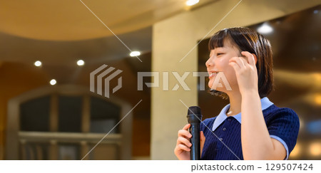 A woman giving a presentation using a microphone 129507424