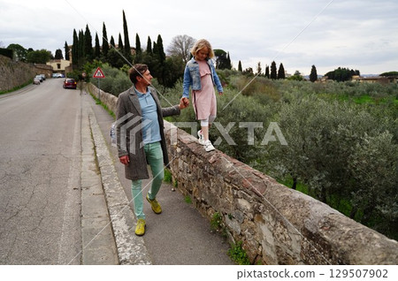 Father and Daughter Walking on Old Stone Wall Father and Daughter Walking on Old Stone Wall 129507902