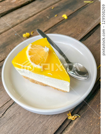 Slice of Lemon Cheesecake on White Plate 129508269
