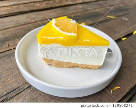 Slice of Lemon Cheesecake on White Plate 129508271