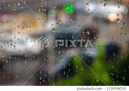wet window background. rain drop on the glass surface. bad weather concept. urban landscape blurred in the distance 129509030