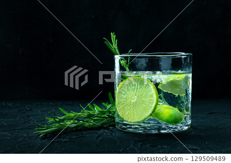 Gin tonic, a glass of gin with soda, lime, rosemary, and plenty of ice Gin tonic, a glass of gin with soda, lime, rosemary, and plenty of ice 129509489