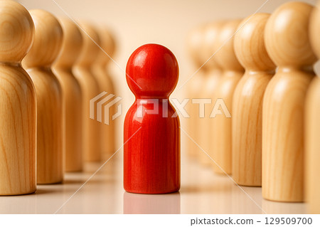 Red Peg, glossy red peg facing mirrored rows of light wood pegs creating contrast and separation under even bright light 129509700