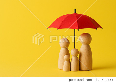Three wooden family figurines under a red umbrella on yellow background representing security, insurance, and protection Three wooden family figurines under a red umbrella on yellow background representing security, insurance, and protection 129509733