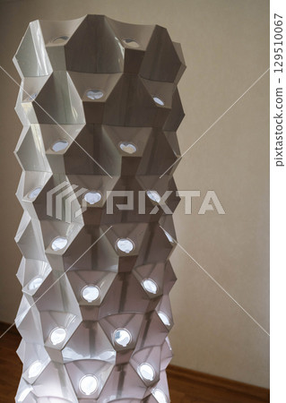 Innovate vertical hydroponic tower featuring blue grow lights, illuminating geometric structure highlighting innovative indoor farming technology for sustainable agriculture, nobody. 129510067