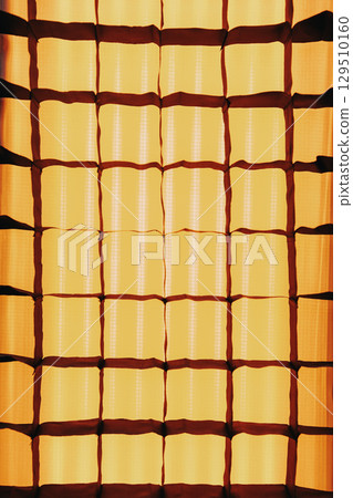 Abstract geometric background of squares. Stripbox close-up. Yellow soft light. Studio lighting equipment for filming. Abstract geometric background of squares. Stripbox close-up. Yellow soft light. Studio lighting equipment for filming. 129510160