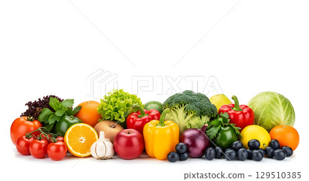 A vibrant assortment of fresh vegetables and fruits including tomatoes, orange slice, garlic, peppers, lettuce, broccoli, onion, cabbage, and blueberries artistically arranged 129510385