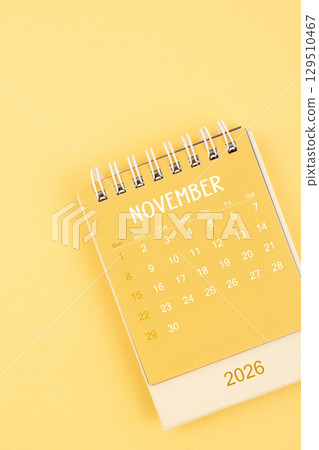 November 2026 Yellow desktop calendar on a yellow color background. 129510467